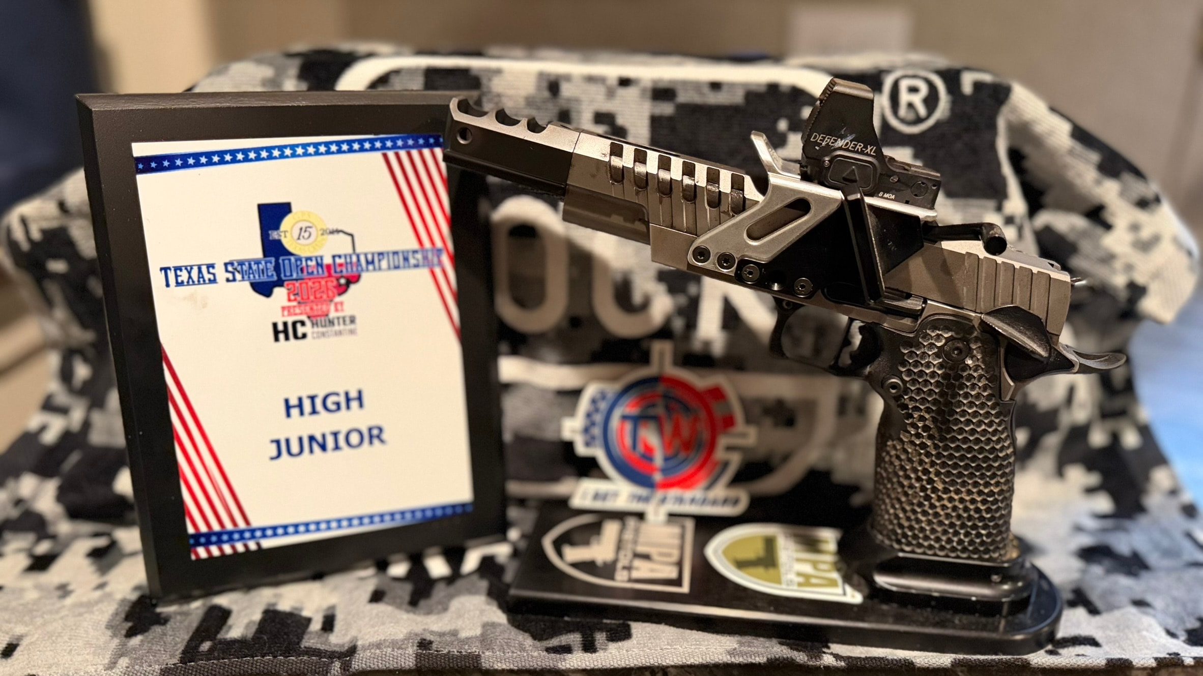 Texas State Open Championship 2026 High Junior award plaque next to a competition pistol with Tripp Wilson branding
