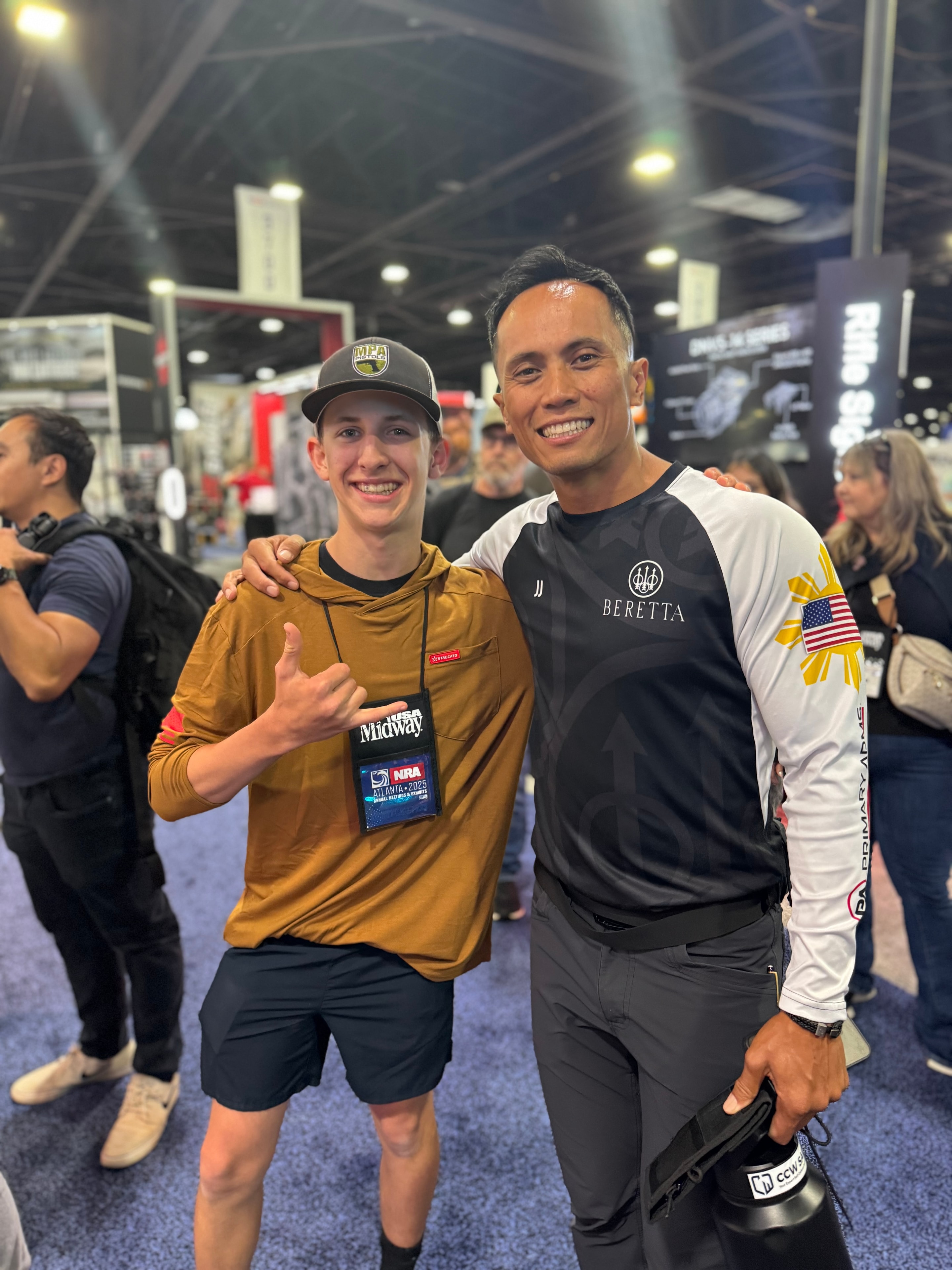 Tripp Wilson with a Beretta-sponsored shooter at the NRA Annual Meeting in Atlanta, Georgia, 2025
