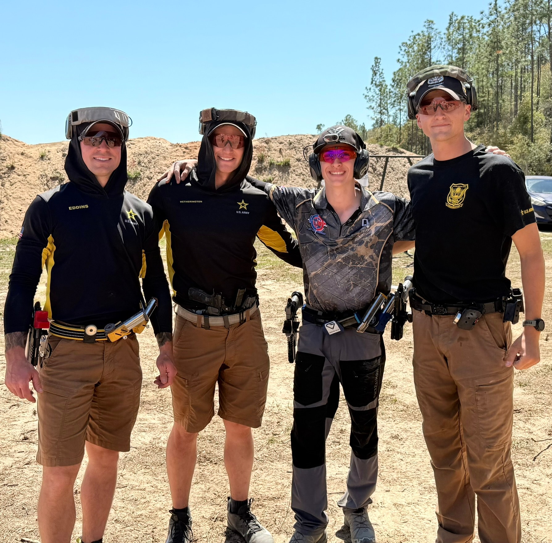 Tripp Wilson with U.S. Army Marksmanship Unit shooters at an outdoor range