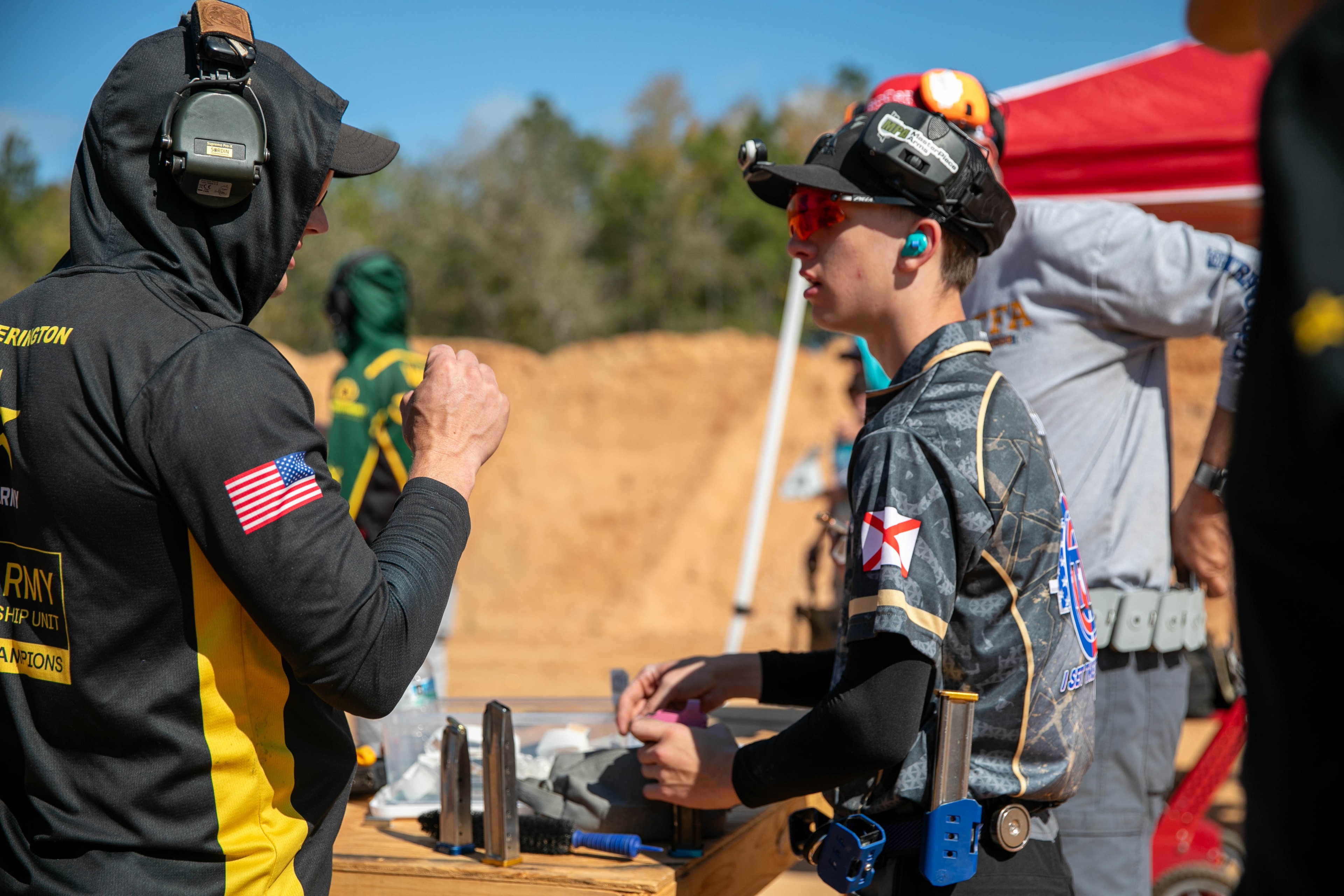 Tripp Wilson and a fellow competitor at an outdoor USPSA match in full tactical gear